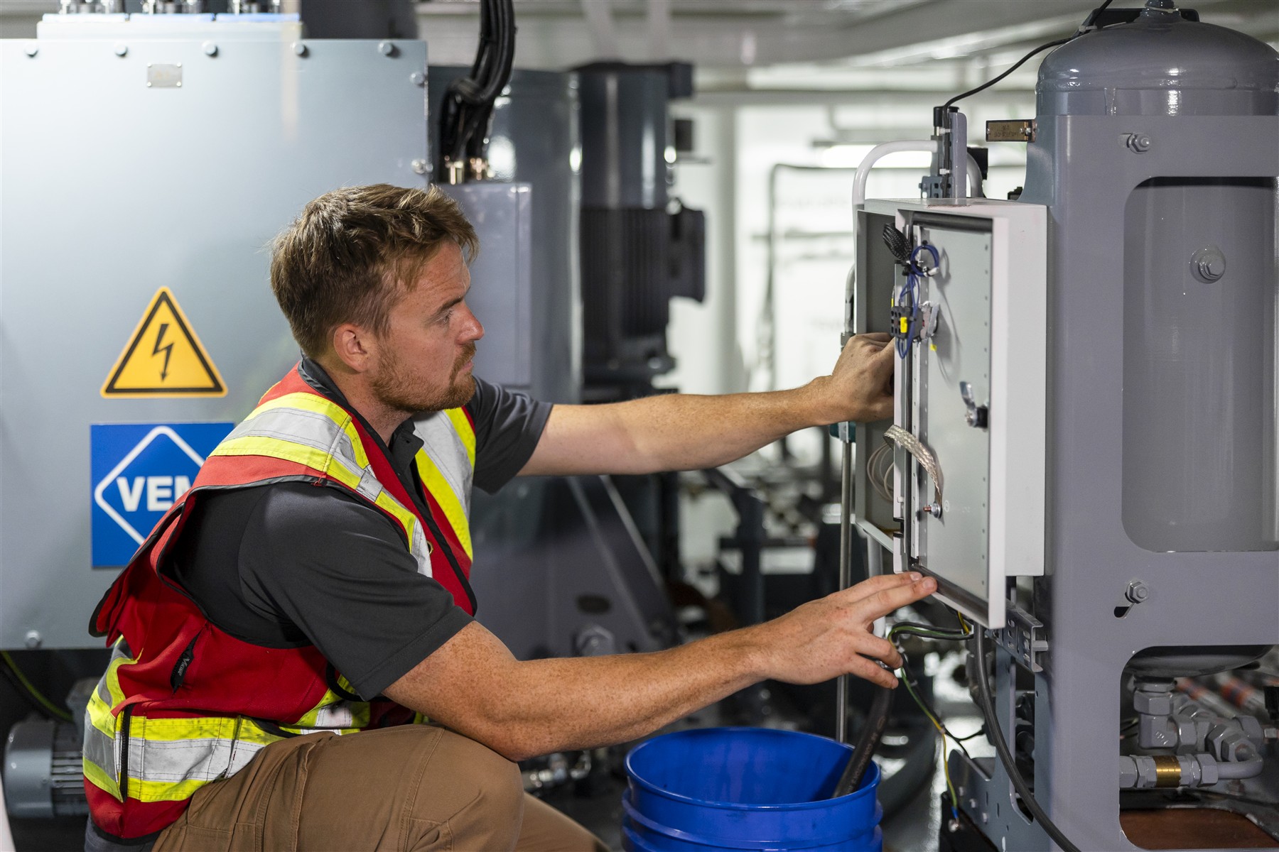 Hands-on inspection of an open equipment control panel